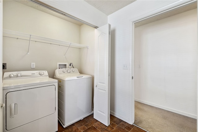 clothes washing area with laundry area, washing machine and dryer, baseboards, and dark carpet