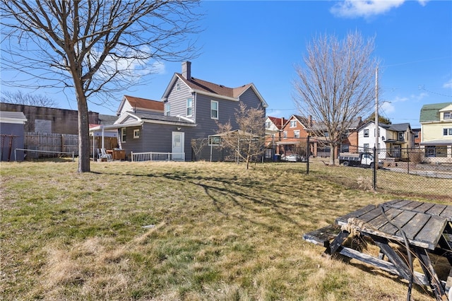 view of yard featuring fence and a residential view