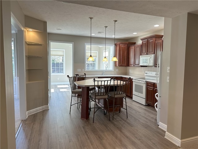 dining space featuring visible vents, baseboards, recessed lighting, a textured ceiling, and light wood-type flooring