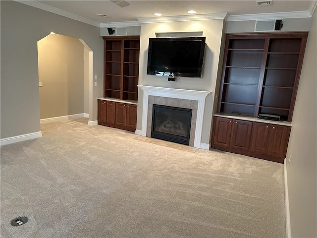 unfurnished living room with carpet flooring, a fireplace, arched walkways, and baseboards