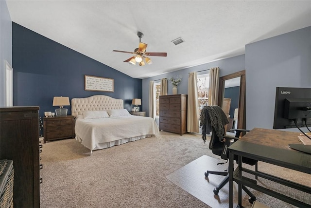 carpeted bedroom with visible vents, ceiling fan, and lofted ceiling