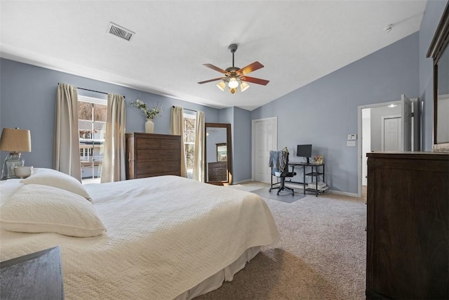 carpeted bedroom with visible vents, baseboards, vaulted ceiling, a closet, and a ceiling fan