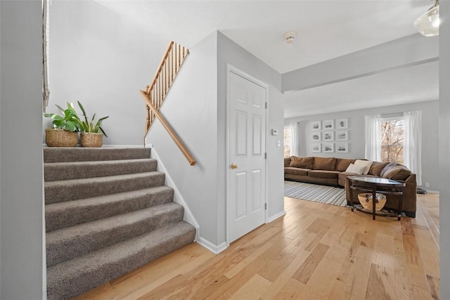 stairway with baseboards and wood finished floors