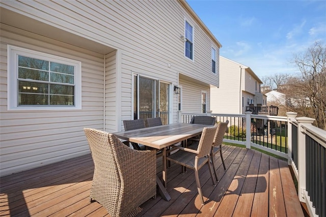 wooden terrace featuring outdoor dining area