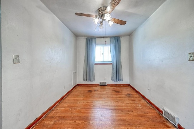 unfurnished room featuring visible vents, baseboards, and light wood-style flooring