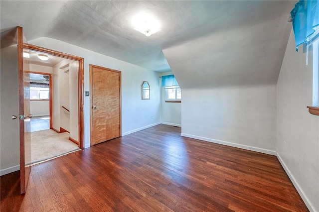 bonus room with baseboards and wood finished floors