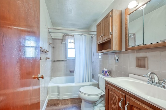 bathroom with tasteful backsplash, tile walls, toilet, shower / tub combo with curtain, and vanity