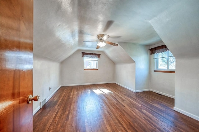 bonus room with visible vents, baseboards, wood finished floors, and vaulted ceiling