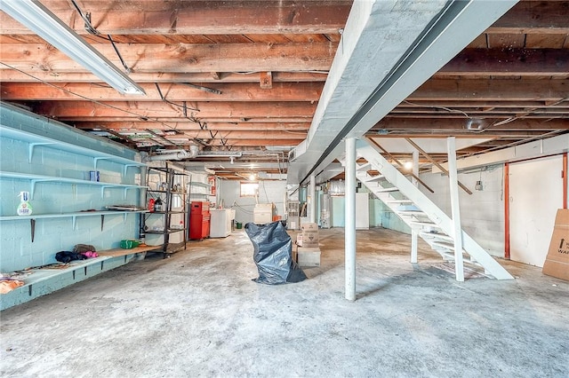 unfinished basement with washer / dryer and stairway