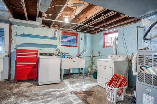 basement featuring separate washer and dryer and a sink