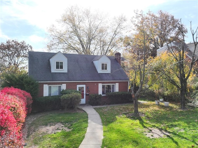 cape cod-style house with a front lawn and brick siding