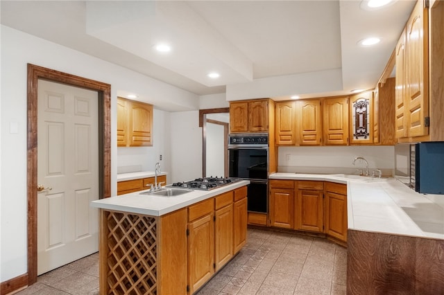 kitchen featuring a sink, dobule oven black, recessed lighting, and stainless steel gas cooktop