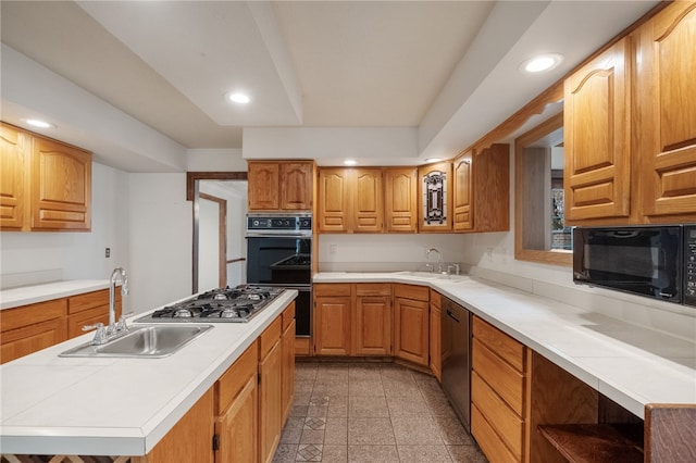 kitchen featuring granite finish floor, recessed lighting, black appliances, and a sink