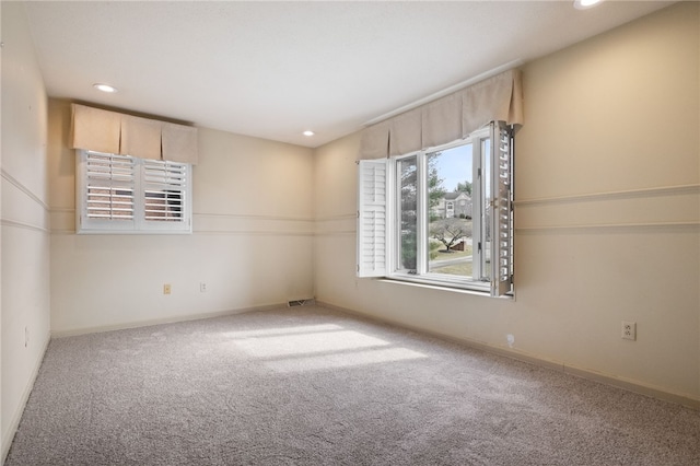 empty room with recessed lighting, visible vents, baseboards, and carpet flooring