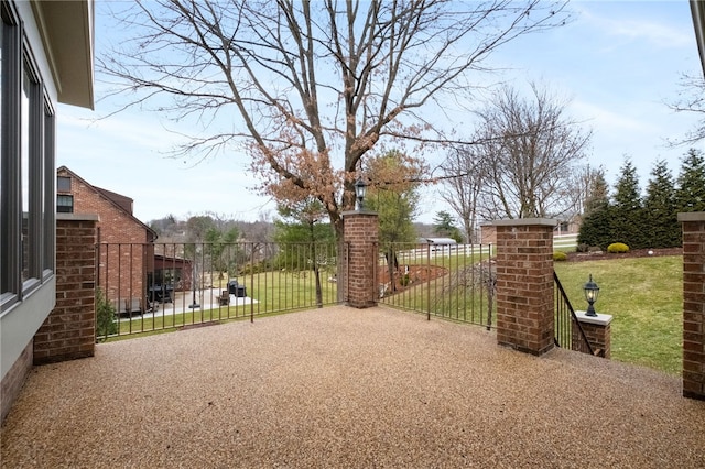 view of gate featuring a lawn