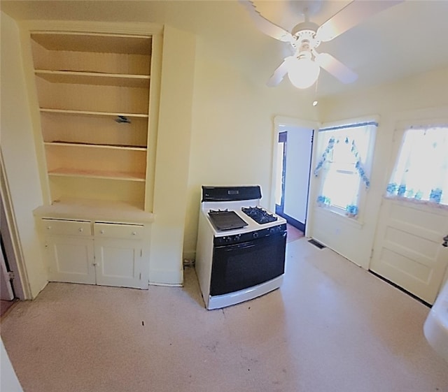 kitchen with visible vents, ceiling fan, white gas range oven, and white cabinetry