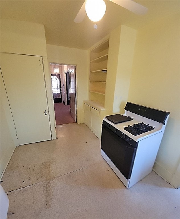 kitchen featuring ceiling fan, built in features, and white gas range