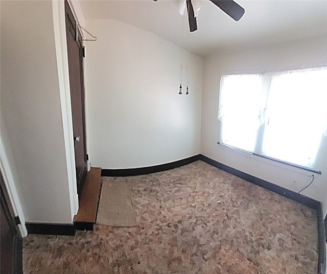 empty room with baseboards and ceiling fan