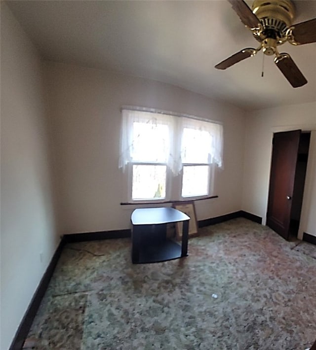 empty room featuring baseboards, carpet floors, and ceiling fan