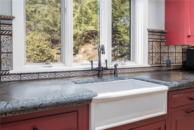 kitchen with a sink and dark countertops