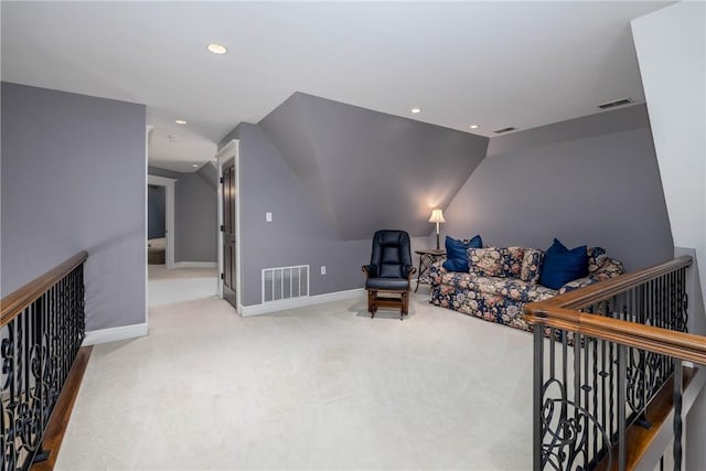 interior space with visible vents, baseboards, and vaulted ceiling