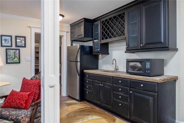 29 Virginia Ln, Cecil, PA 15317 - kitchen with black microwave, freestanding refrigerator, crown molding, light countertops, and dark cabinets