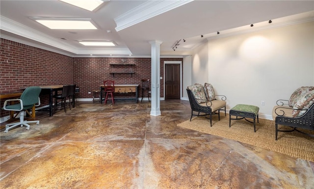 interior space featuring ornamental molding, finished concrete floors, brick wall, baseboards, and ornate columns