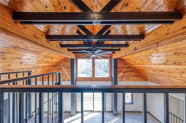 interior space with wooden walls, carpet, wood ceiling, and vaulted ceiling with beams