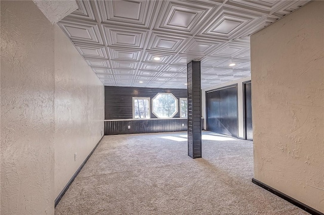 empty room featuring baseboards, carpet floors, recessed lighting, an ornate ceiling, and a textured wall