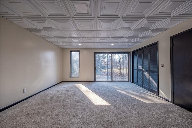 unfurnished room featuring recessed lighting, an ornate ceiling, baseboards, and carpet floors