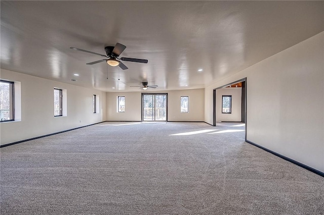 carpeted spare room featuring baseboards