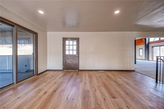 interior space featuring recessed lighting, light wood-type flooring, plenty of natural light, and baseboards