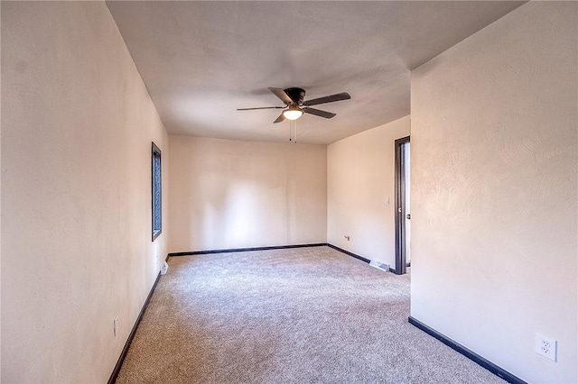 carpeted empty room with baseboards and ceiling fan