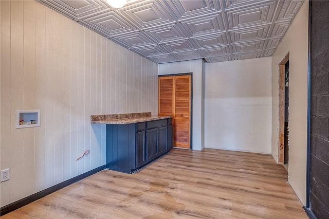 interior space with light wood-style flooring and an ornate ceiling