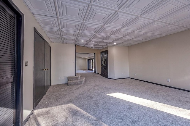 carpeted spare room with recessed lighting, baseboards, an ornate ceiling, and stairs