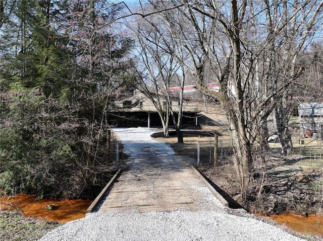 view of road featuring gravel driveway