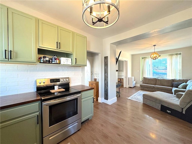 kitchen featuring a chandelier, stainless steel range with electric stovetop, and green cabinets