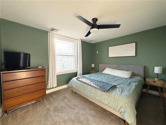 carpeted bedroom featuring visible vents, baseboards, and ceiling fan