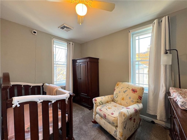 bedroom featuring visible vents, ceiling fan, and dark carpet