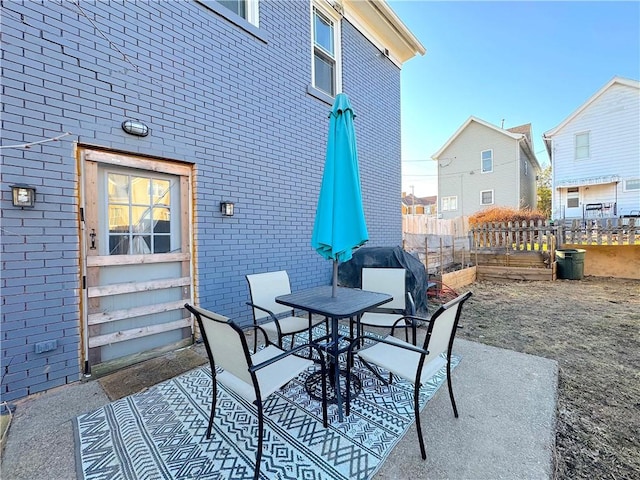 view of patio / terrace with outdoor dining area and fence