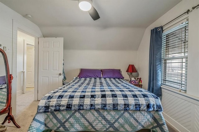 bedroom with a ceiling fan, vaulted ceiling, carpet, and baseboards