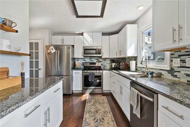 kitchen with white cabinets, stainless steel appliances, and a sink