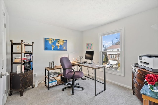 carpeted office space featuring baseboards