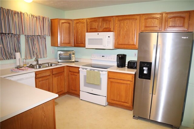 6233 Oyster Bay Ct, South Fayette, PA 15017 - kitchen featuring white appliances, a sink, light countertops, and brown cabinets