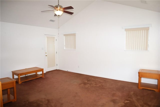 carpeted empty room featuring visible vents, high vaulted ceiling, and a ceiling fan