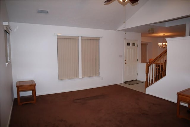 carpeted spare room featuring visible vents, baseboards, lofted ceiling, ceiling fan, and stairs