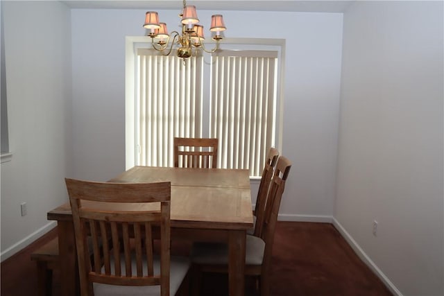 dining room featuring baseboards and an inviting chandelier