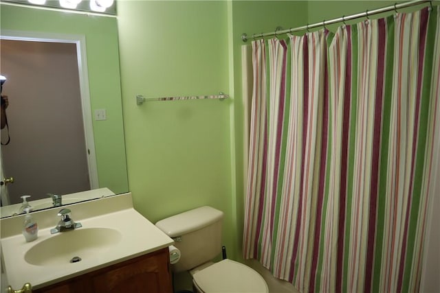 bathroom with vanity, a shower with shower curtain, and toilet