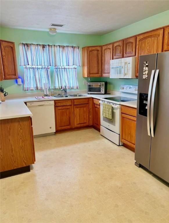 6233 Oyster Bay Ct, South Fayette, PA 15017 - kitchen with white appliances, a sink, brown cabinetry, and light flooring