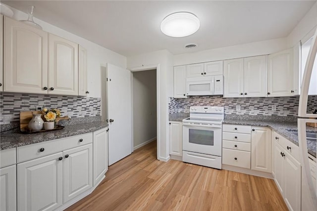 kitchen featuring white appliances, white cabinets, light wood-style floors, and visible vents